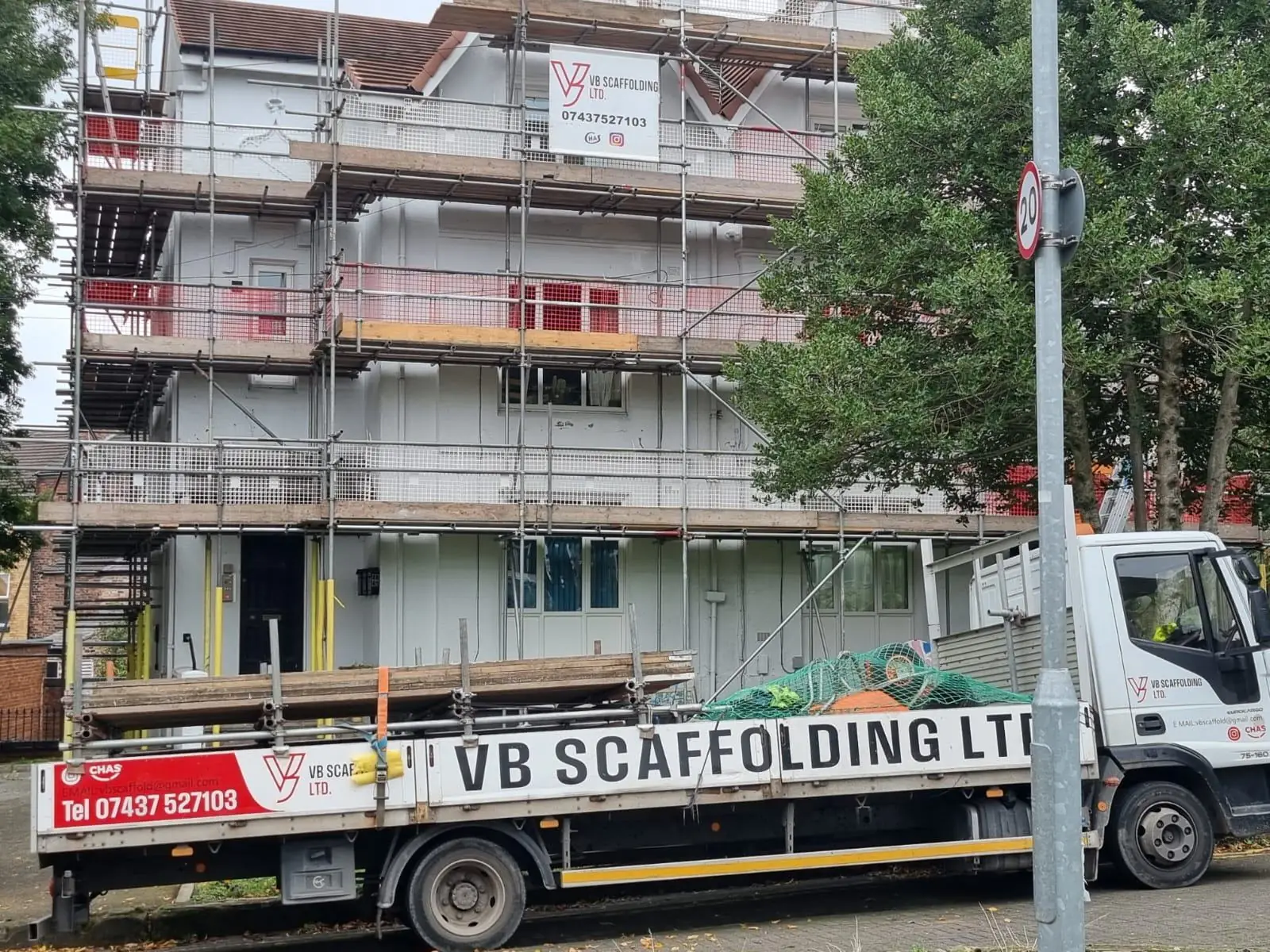VB Scaffolding branded truck parked outside a live residential scaffold job